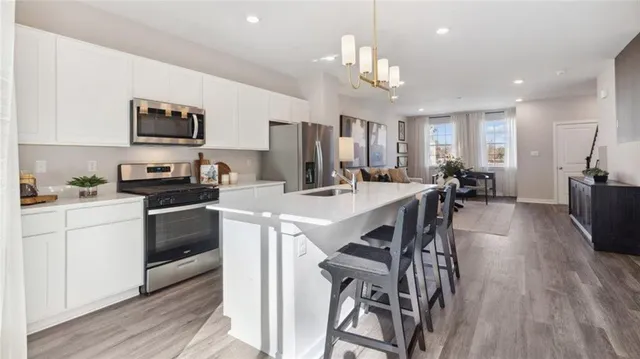 a kitchen with a table chairs sink and cabinets