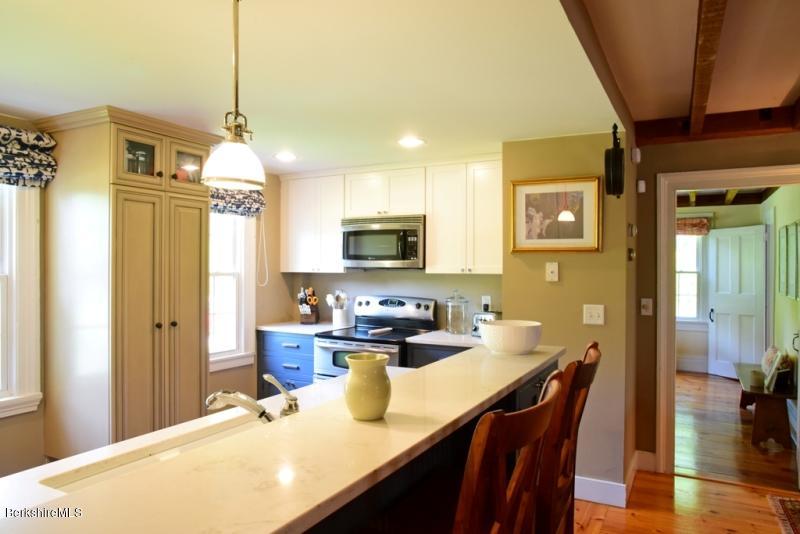 2922 State Road Richmond, MA 01254 - Photo 13 of 36 a kitchen with a table and chairs in it