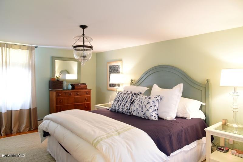 2922 State Road Richmond, MA 01254 - Photo 21 of 36 a bedroom with a bed and a chandelier