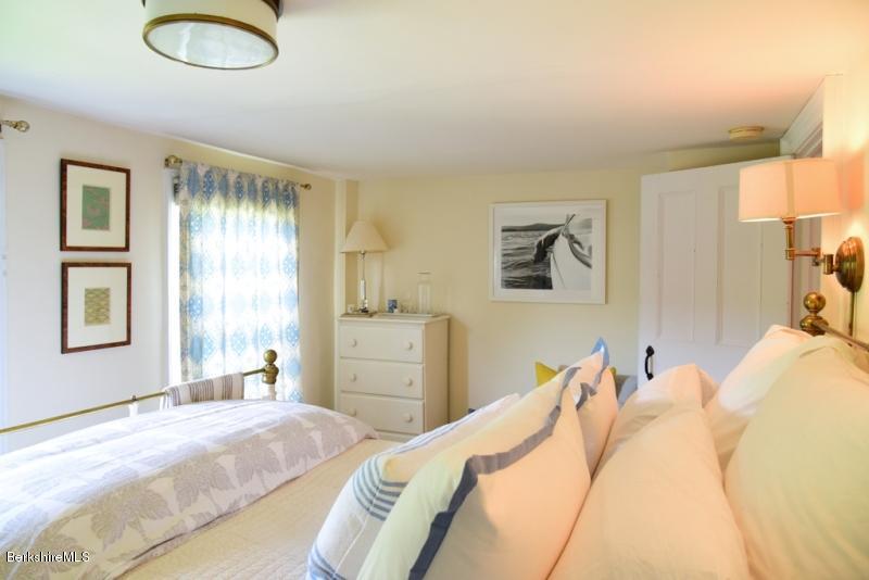 2922 State Road Richmond, MA 01254 - Photo 23 of 36 a bedroom with a bed and a large mirror