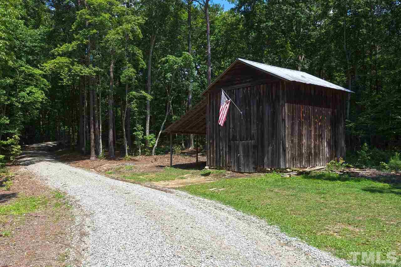 8500 McKee Road Rougemont, NC 27572 - Photo 3 of 25 a backyard of a house with barbeque oven and trees