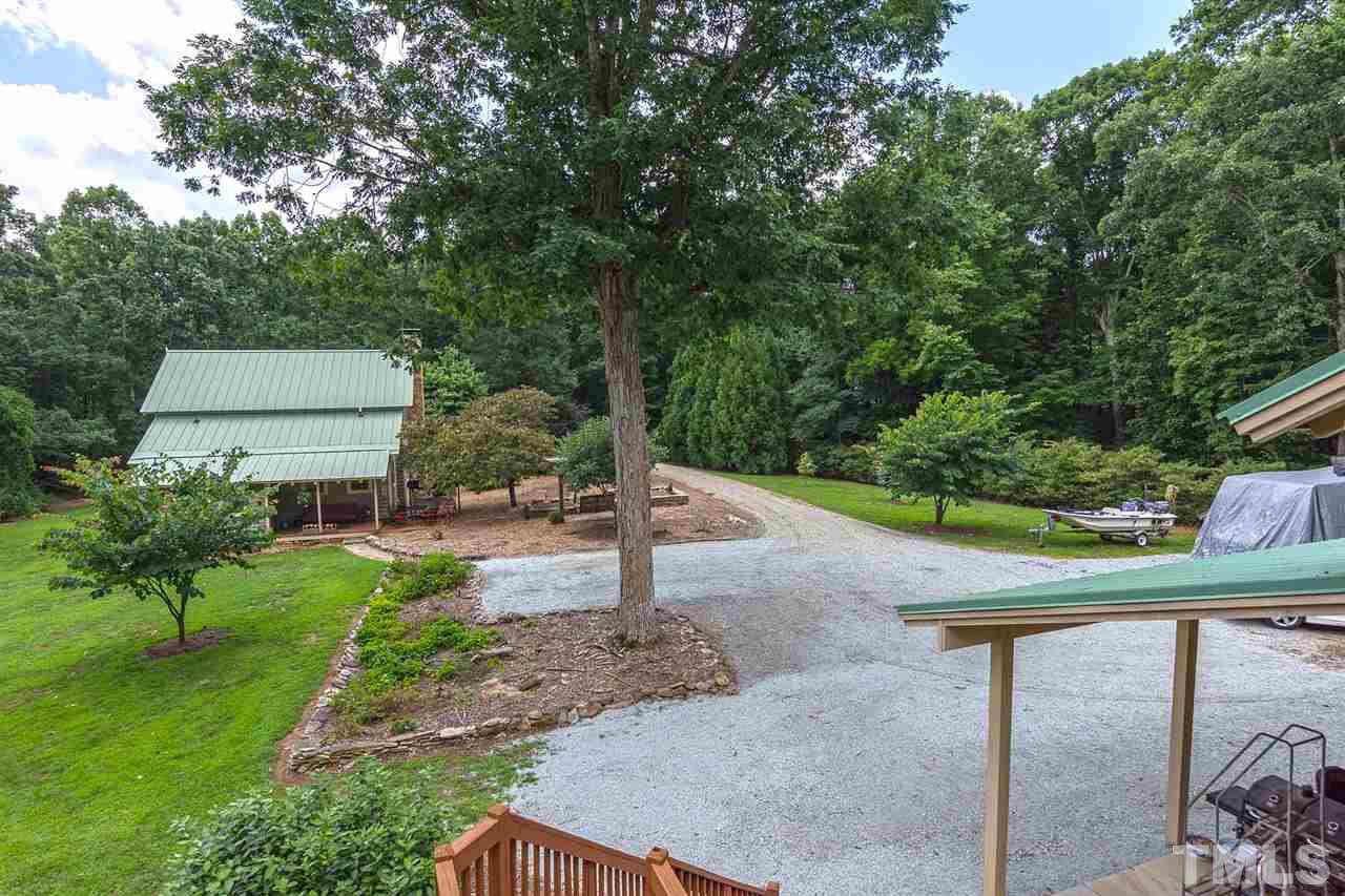 8500 McKee Road Rougemont, NC 27572 - Photo 23 of 25 a view of a yard with plants and a bench