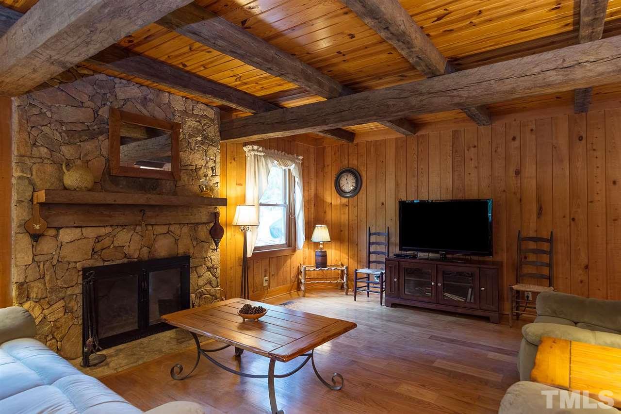 8500 McKee Road Rougemont, NC 27572 - Photo 5 of 25 a living room with furniture a fireplace and a flat screen tv
