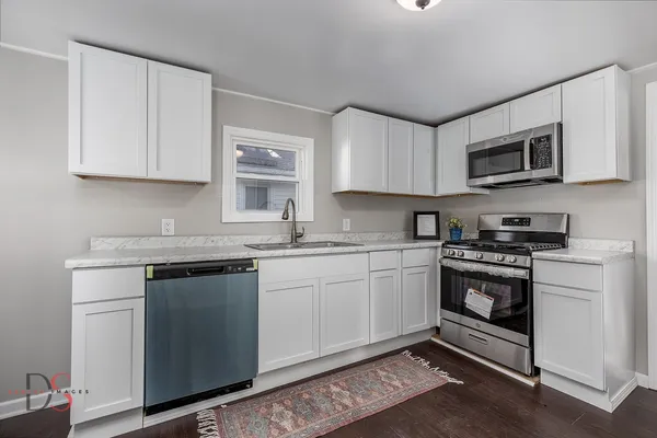 a kitchen with stainless steel appliances granite countertop a sink and a stove
