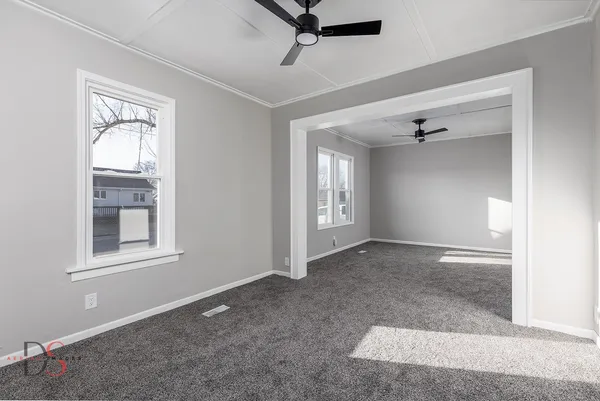 an empty room with windows and closet