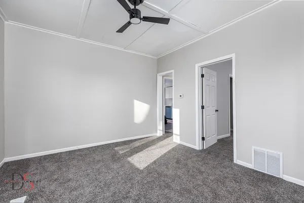 an empty room with a empty space and windows