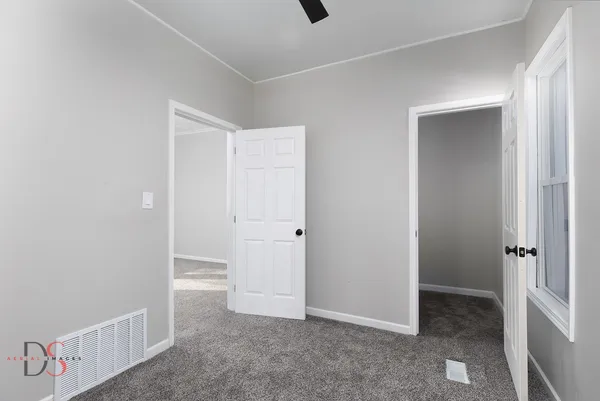 an empty room with white cabinet
