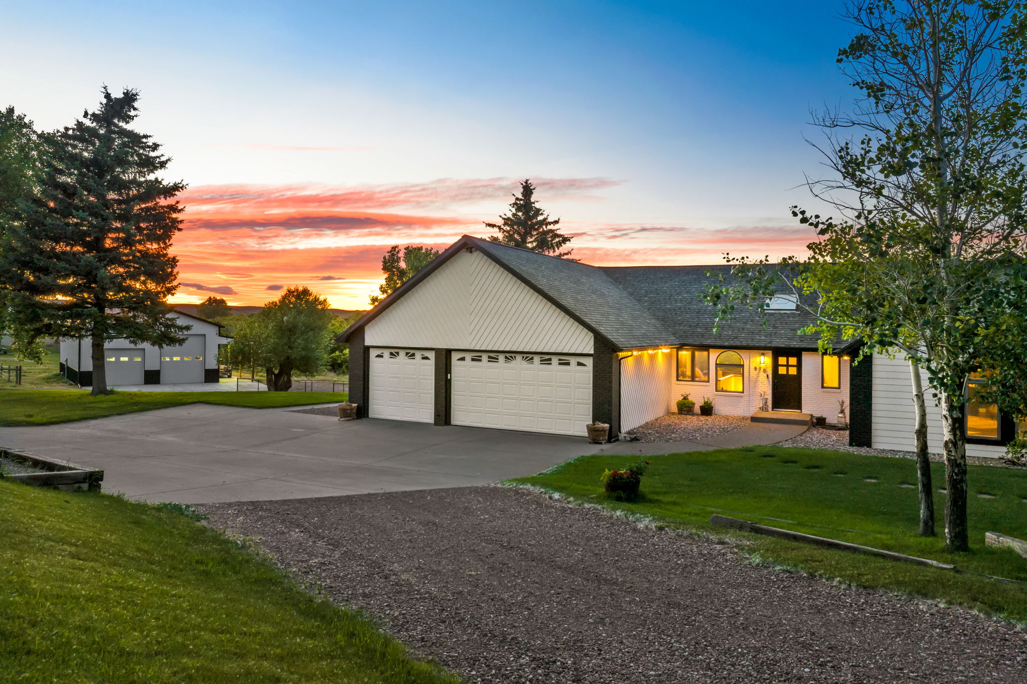 575 Wilson Butte Road Great Falls, MT 59405 - Photo 1 of 1 View of front of property with driveway, an attached garage, roof with shingles, and a front lawn