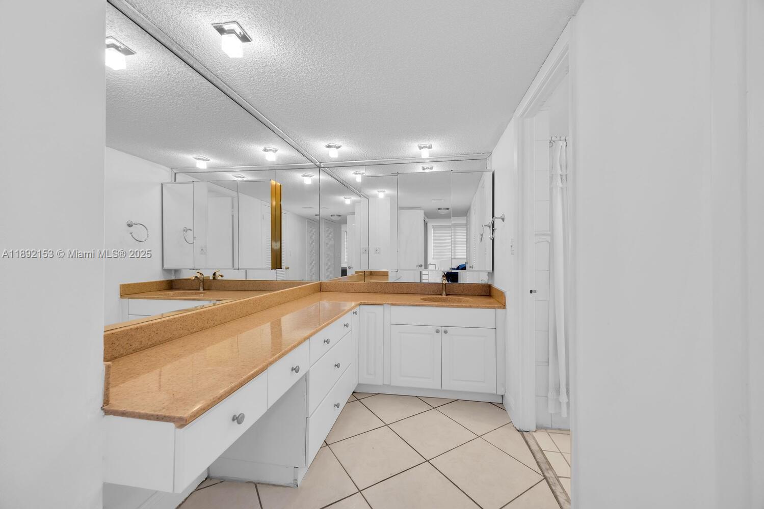 6039 Collins Avenue, Unit 311 Miami Beach, FL 33140 - Photo 15 of 26 a large kitchen with a sink and cabinets