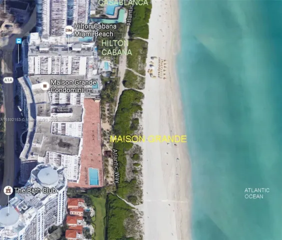 an aerial view of a residential apartment building with a yard