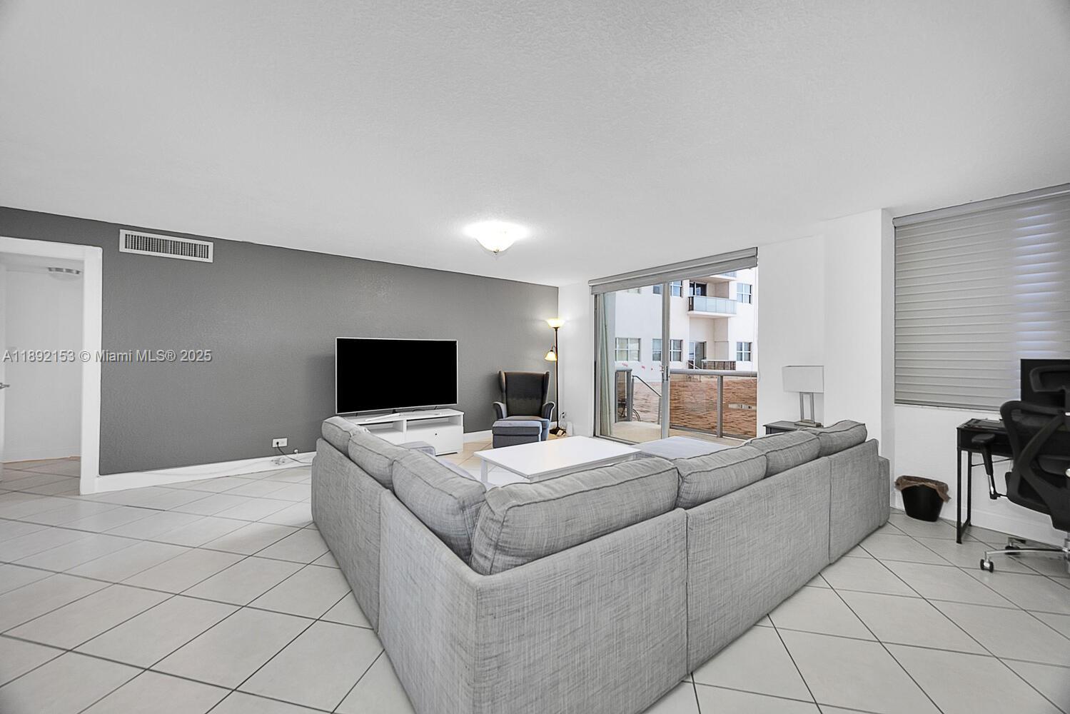 6039 Collins Avenue, Unit 311 Miami Beach, FL 33140 - Photo 10 of 26 a room with a bed and a television