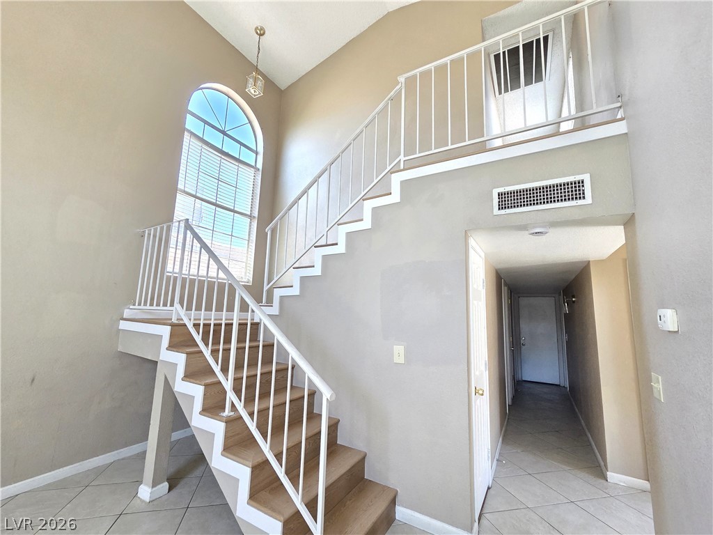 2882 Sandyfalls Way Las Vegas, NV 89142 - Photo 6 of 18 Natural illumination fills this open staircase and hallway, leading to a second-story landing.