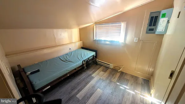 a view of a room with wooden floor