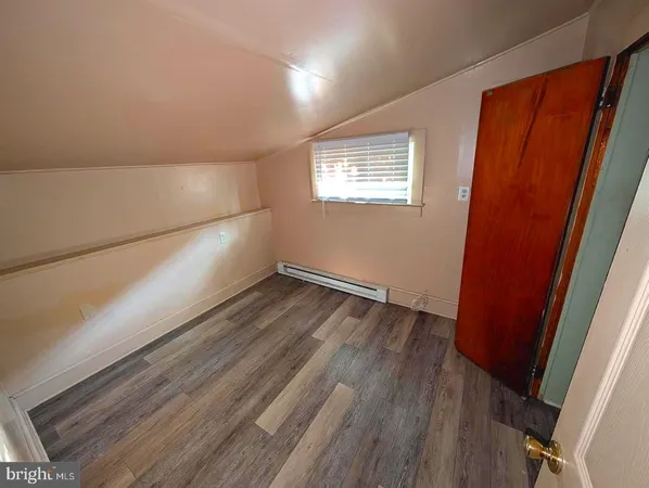 a view of an empty room and wooden floor