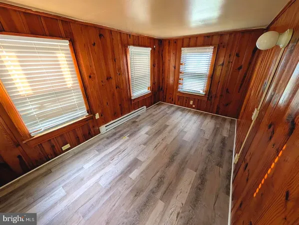 a view of an empty room and wooden floor