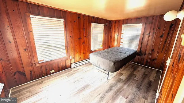 a living room with a bed and a window
