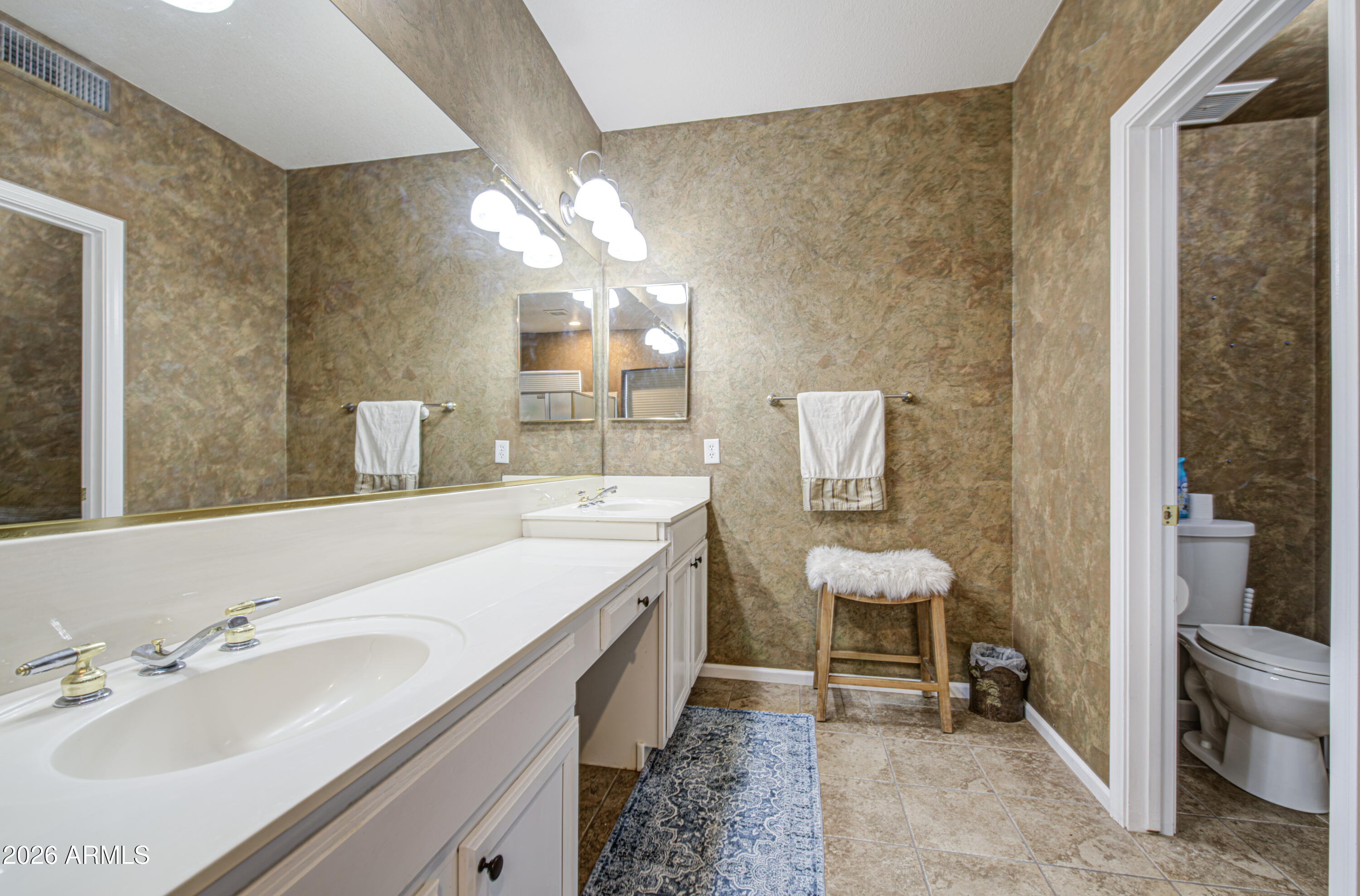 12403 West Monte Vista Road Avondale, AZ 85392 - Photo 34 of 63 a bathroom with a double vanity sink toilet and a mirror