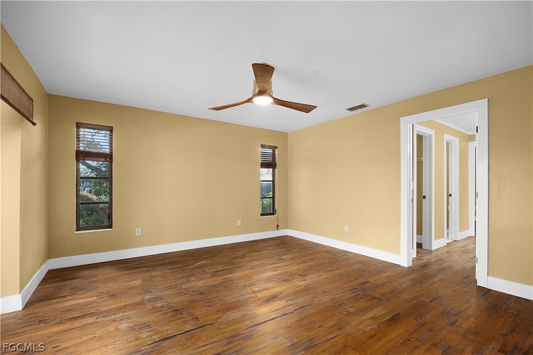13520 Island Road Fort Myers, FL 33905 - Photo 11 of 36 a view of empty room with wooden floor and fan