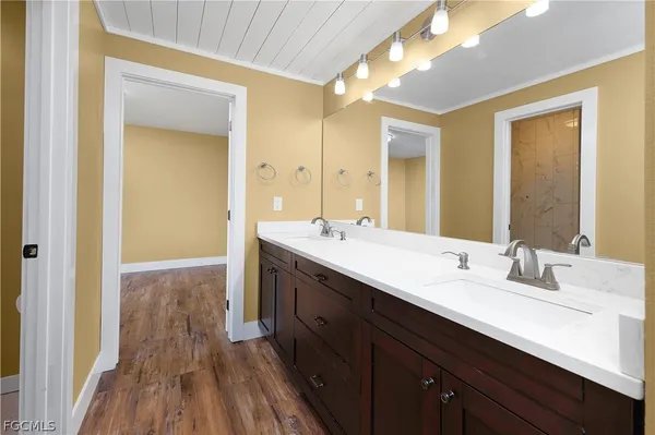 a bathroom with a double vanity sink and a mirror
