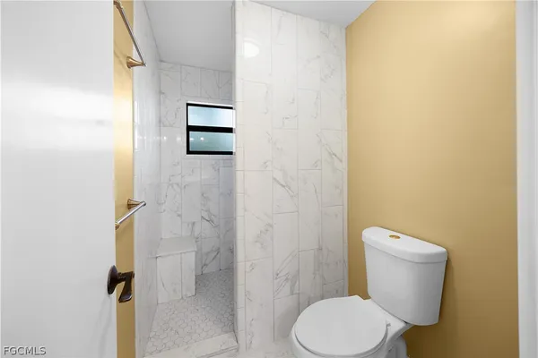 a bathroom with a shower and a mirror