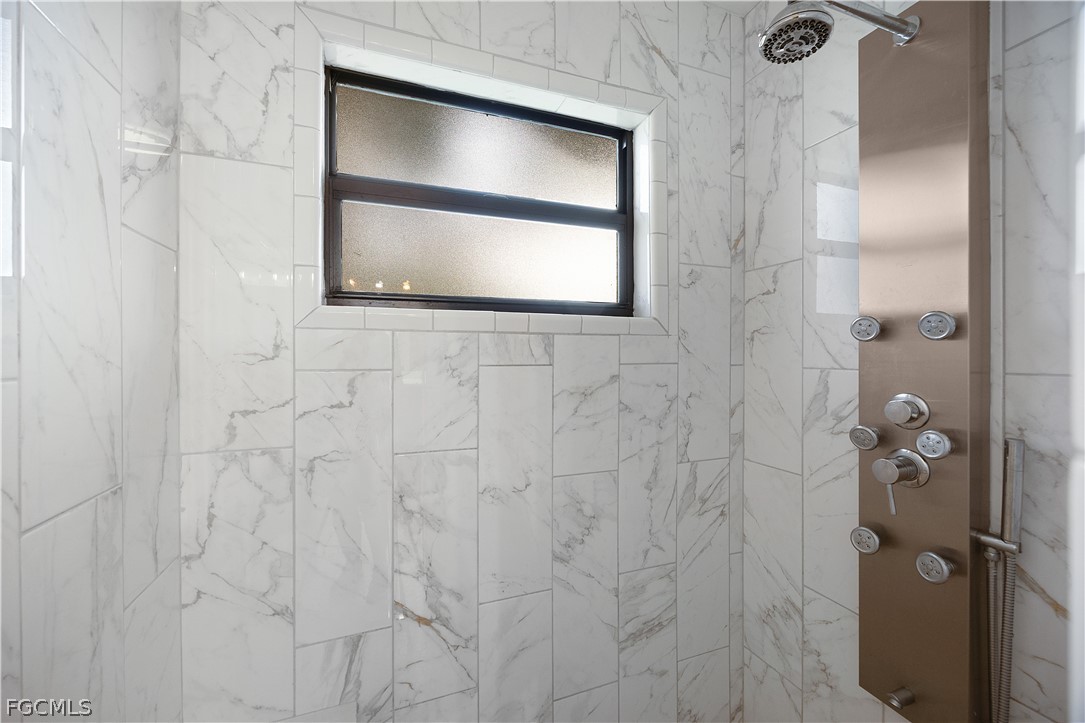 13520 Island Road Fort Myers, FL 33905 - Photo 15 of 36 a bathroom with a shower and a mirror