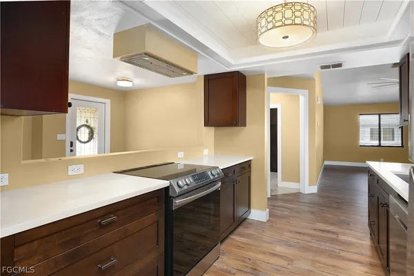 a kitchen with a sink cabinets and window