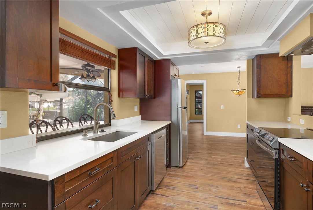 13520 Island Road Fort Myers, FL 33905 - Photo 20 of 36 a kitchen with a sink cabinets and window