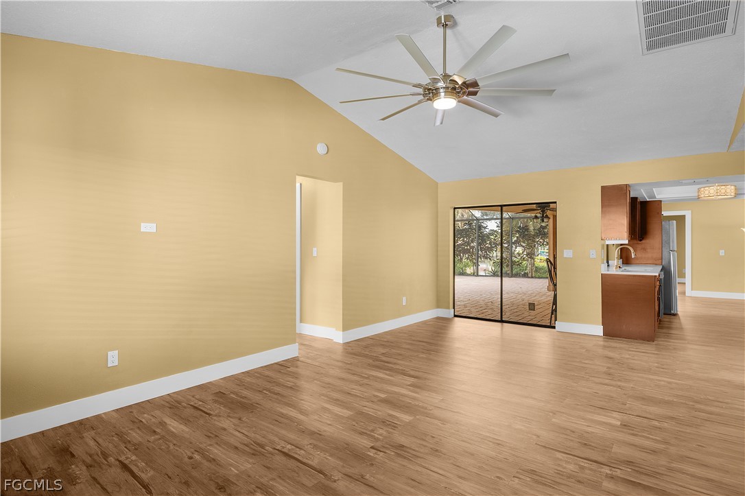 13520 Island Road Fort Myers, FL 33905 - Photo 22 of 36 a view of an empty room with wooden floor and a ceiling fan