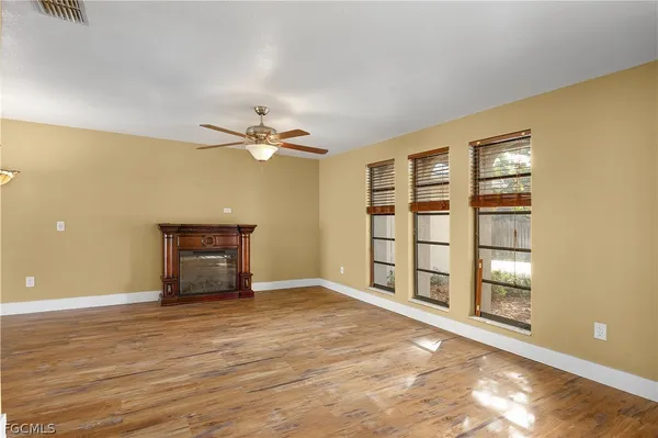 a view of an empty room with a window and closet