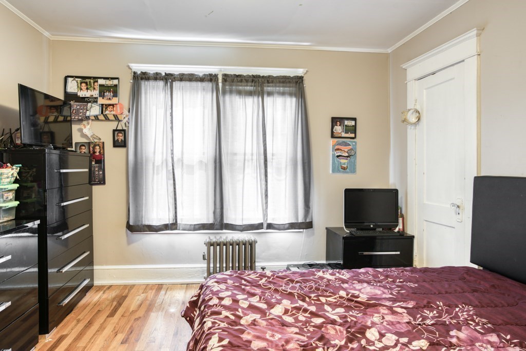 70-72 Windemere Street Springfield, MA 01104 - Photo 14 of 42 a bedroom with a bed and a television