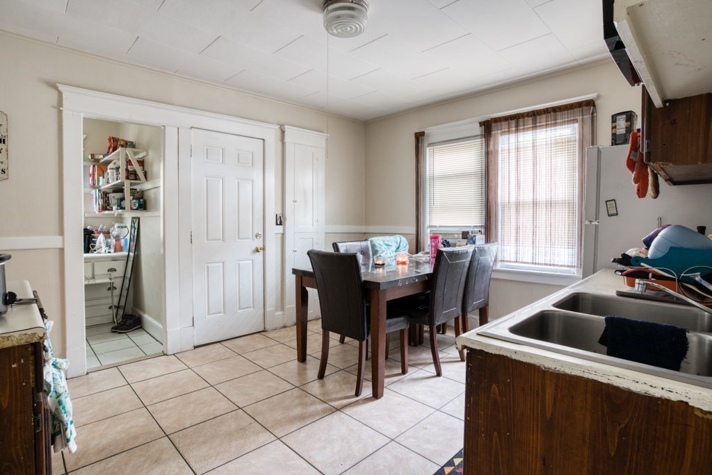 70-72 Windemere Street Springfield, MA 01104 - Photo 23 of 42 a kitchen that has a sink a table and chairs in it