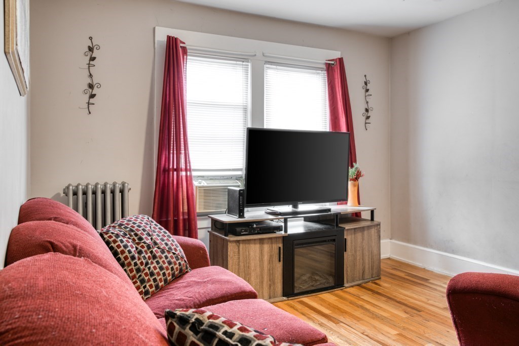 70-72 Windemere Street Springfield, MA 01104 - Photo 8 of 42 a bedroom with a bed and flat screen tv