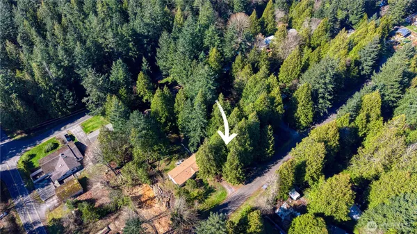 an aerial view of a house with a yard and garden