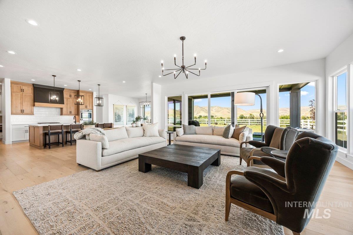 13746 North Ruffed Grouse Way Boise, ID 83714 - Photo 6 of 43 Living area featuring a chandelier, recessed lighting, and light wood finished floors