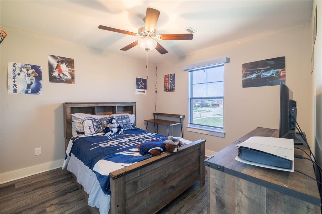4721 Dry Creek Road Sherman, TX 75092 - Photo 15 of 25 a bed room with a bed window and a chandelier