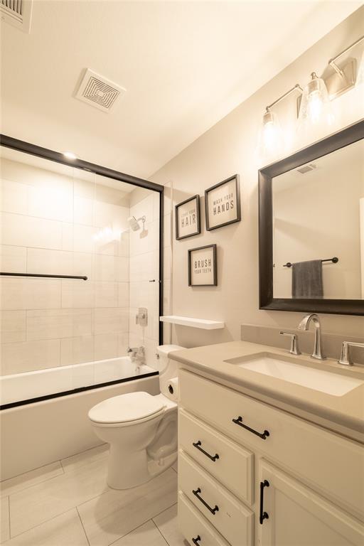 4721 Dry Creek Road Sherman, TX 75092 - Photo 16 of 25 a bathroom with a sink mirror vanity and toilet