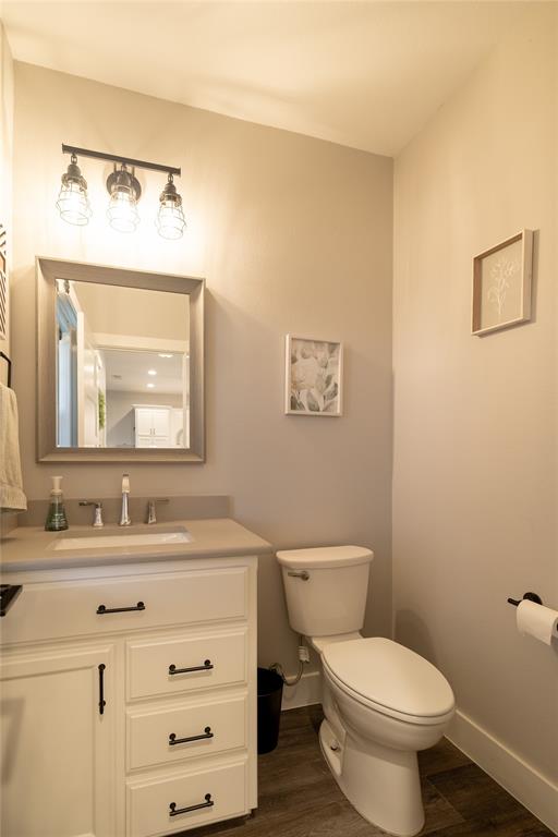 4721 Dry Creek Road Sherman, TX 75092 - Photo 17 of 25 a bathroom with a toilet a sink a mirror and a window