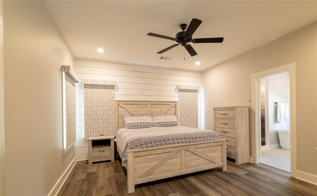 4721 Dry Creek Road Sherman, TX 75092 - Photo 7 of 25 a bedroom with a bed and a chandelier