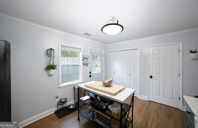 a view of a dining room with furniture and wooden floor