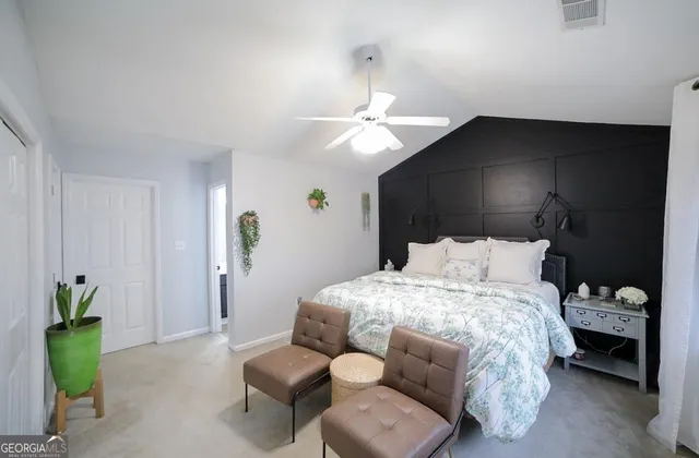 a bedroom with a bed and ceiling fan