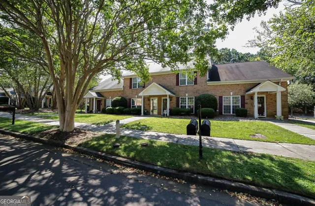 a house that has a tree in front of the house