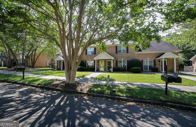 a front view of a house with garden