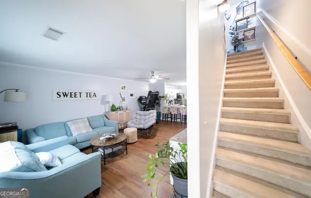 a living room with furniture and a stairs