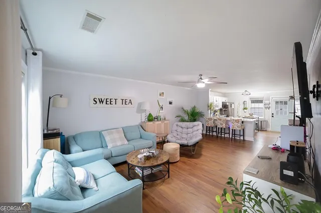 a living room with furniture and wooden floor