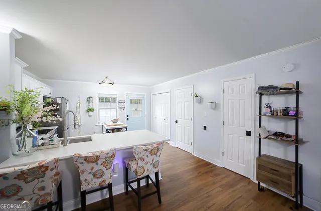 a view of a dining room with furniture and a potted plant