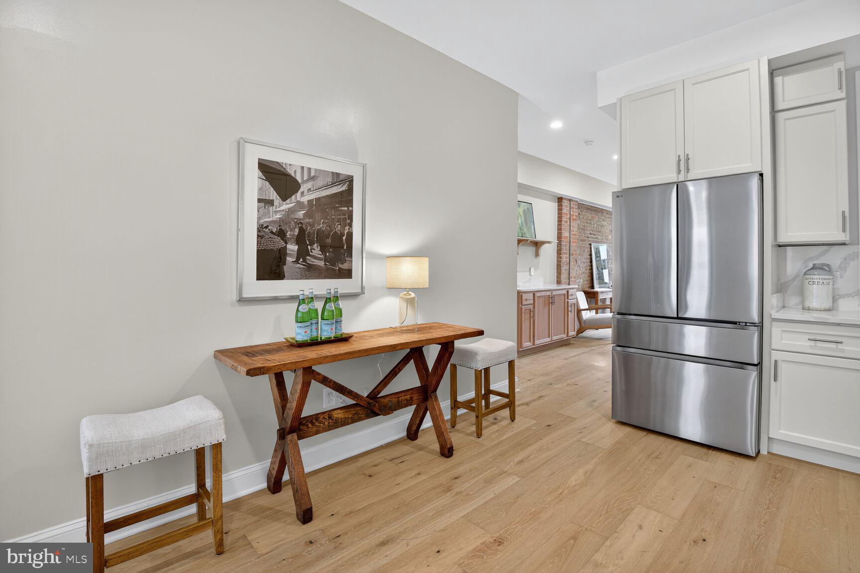 316 U Street Northwest Washington, DC 20001 - Photo 11 of 37 a kitchen with stainless steel appliances wooden floor and chairs