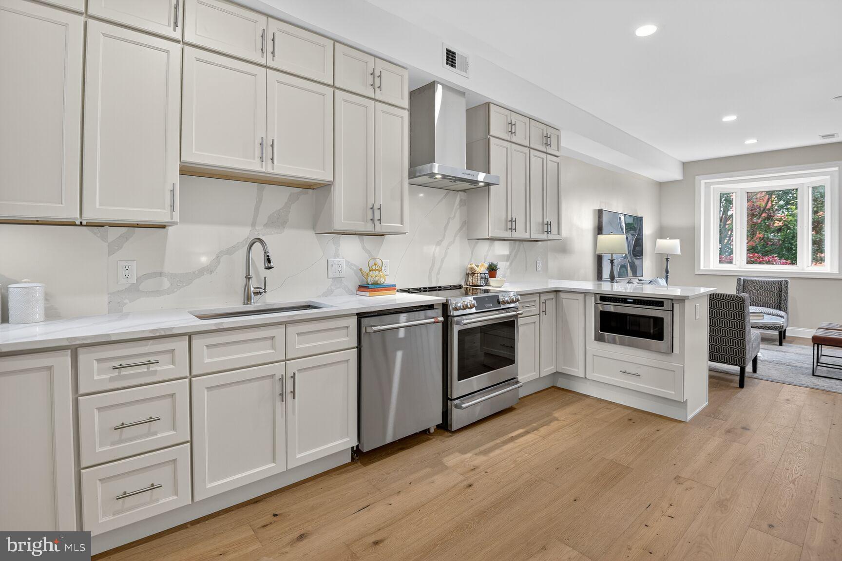 316 U Street Northwest Washington, DC 20001 - Photo 10 of 37 a kitchen with granite countertop white cabinets and white appliances