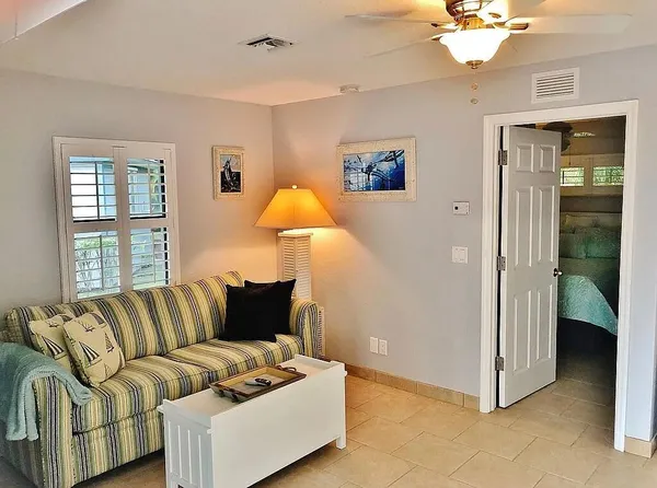 a kitchen with granite countertop a sink dining table and chairs