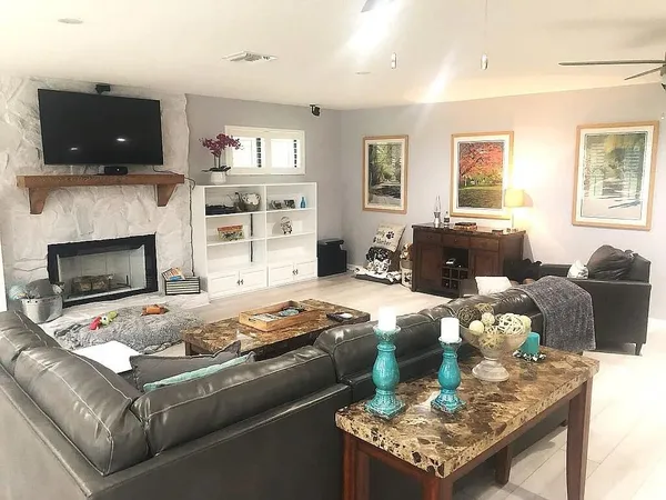 a bathroom with a granite countertop toilet sink and mirror