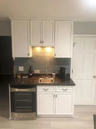 a view of a livingroom with furniture and a flat screen tv